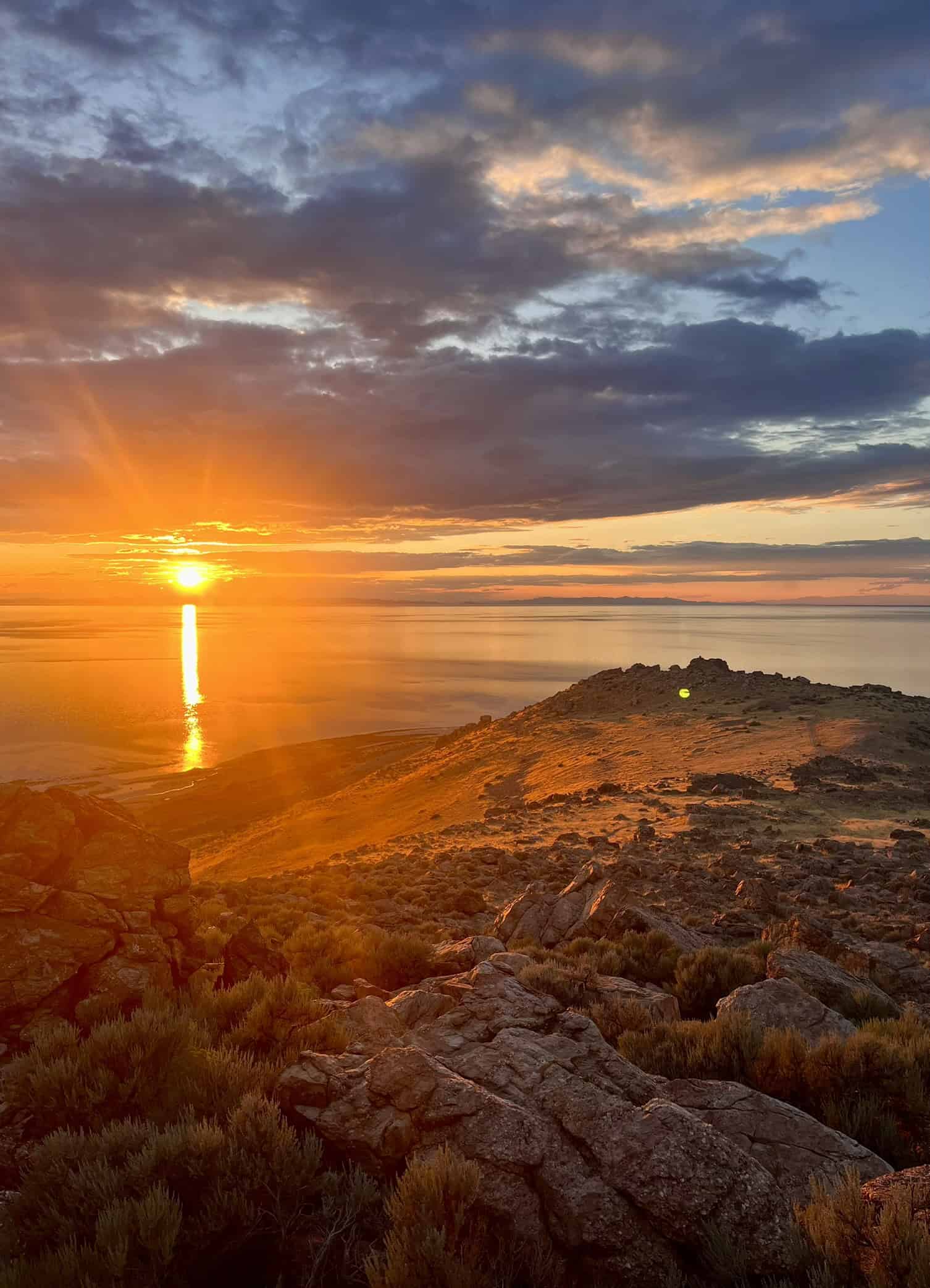 Golden sunset over the Great Salt Lake viewed from a rocky overlook on Antelope Island.