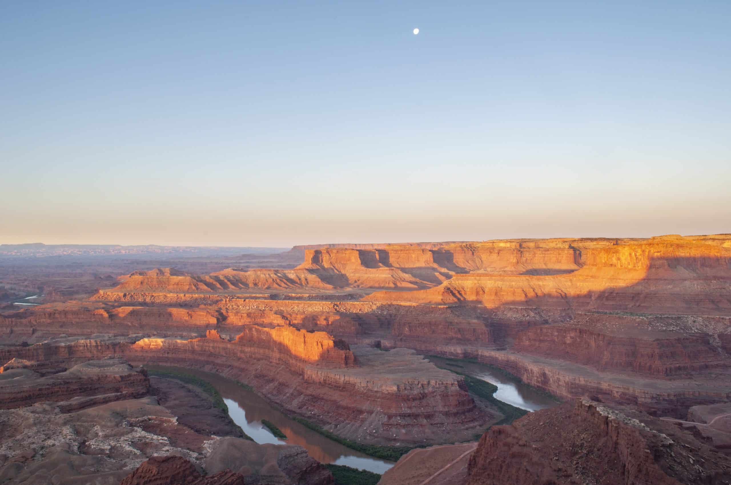 Morning light on the red rocks with a river meandering through the canyon at Deadhorse Point State Park, Utah. 