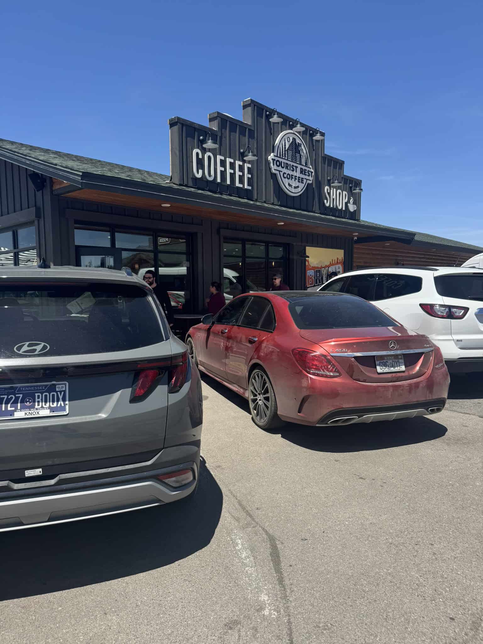 The exterior of a modern coffee shop with bold signage under a clear blue sky, a perfect stop for your Bryce Canyon Itinerary
