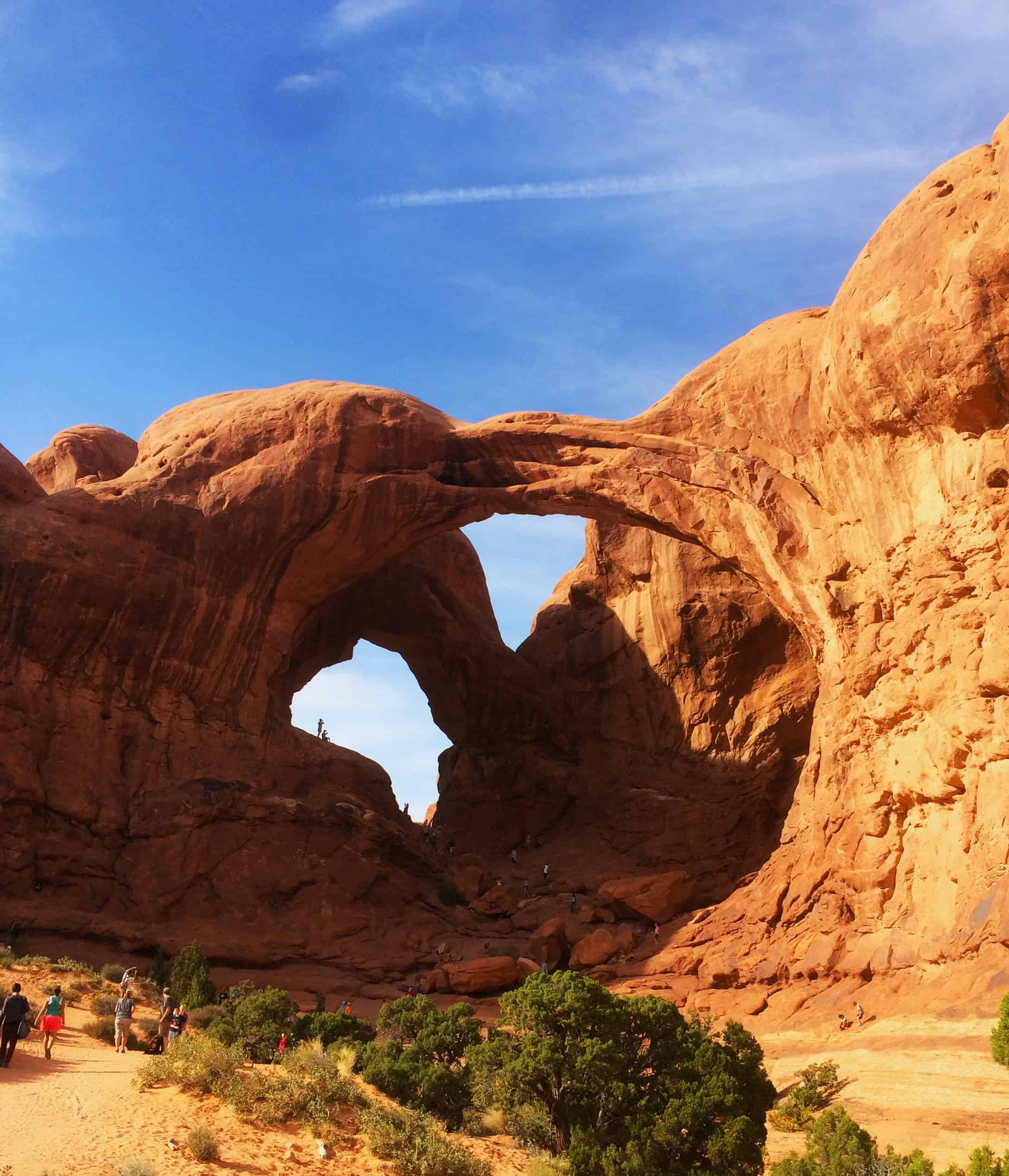 Iconic Double Arch rock formation with two massive stone arches set against red sandstone cliffs in Arches National Park, Utah