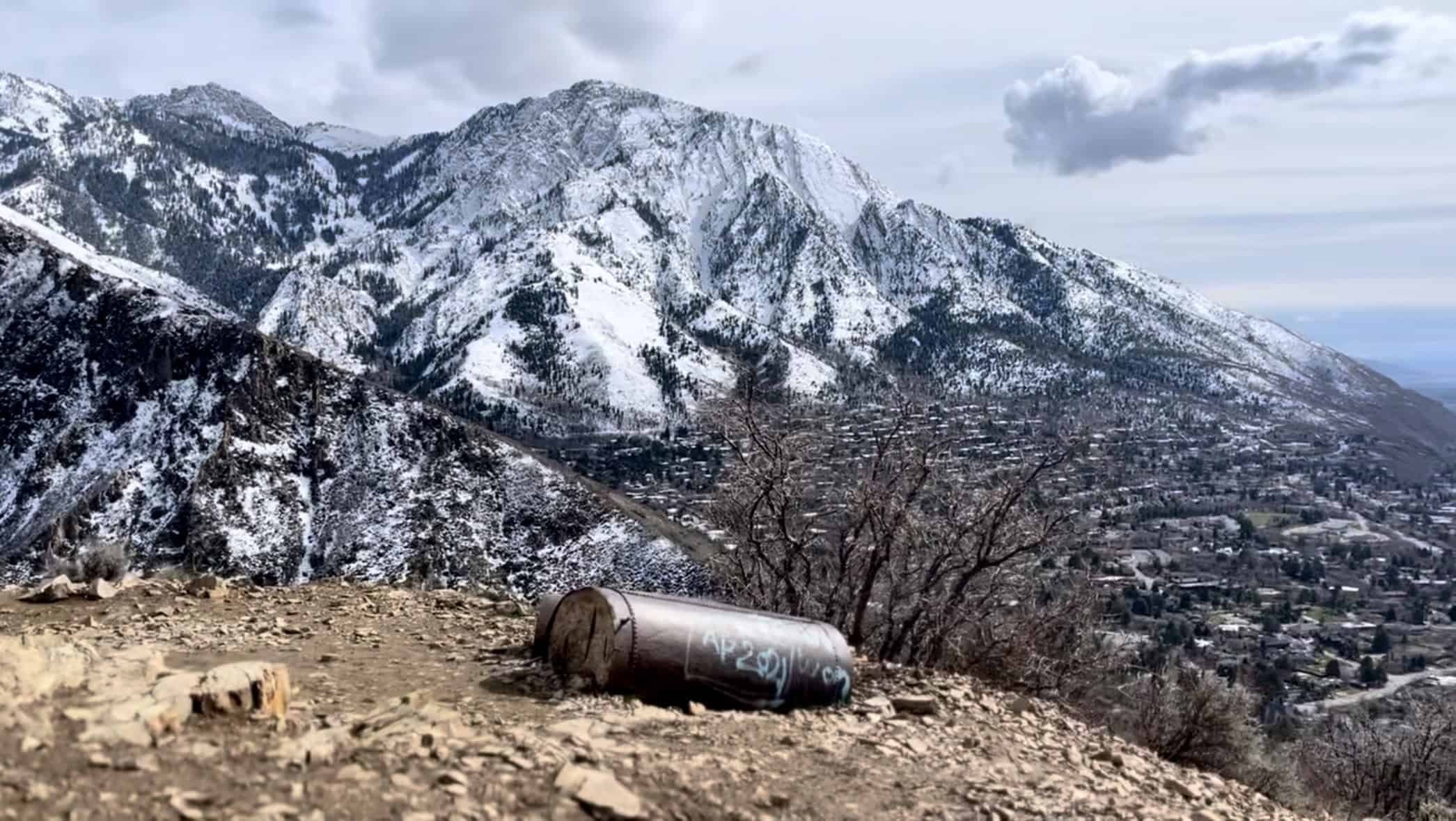 Old abandoned pipeline sits in the foreground with epic snowcapped mountain in the backdrop near Salt Lake City