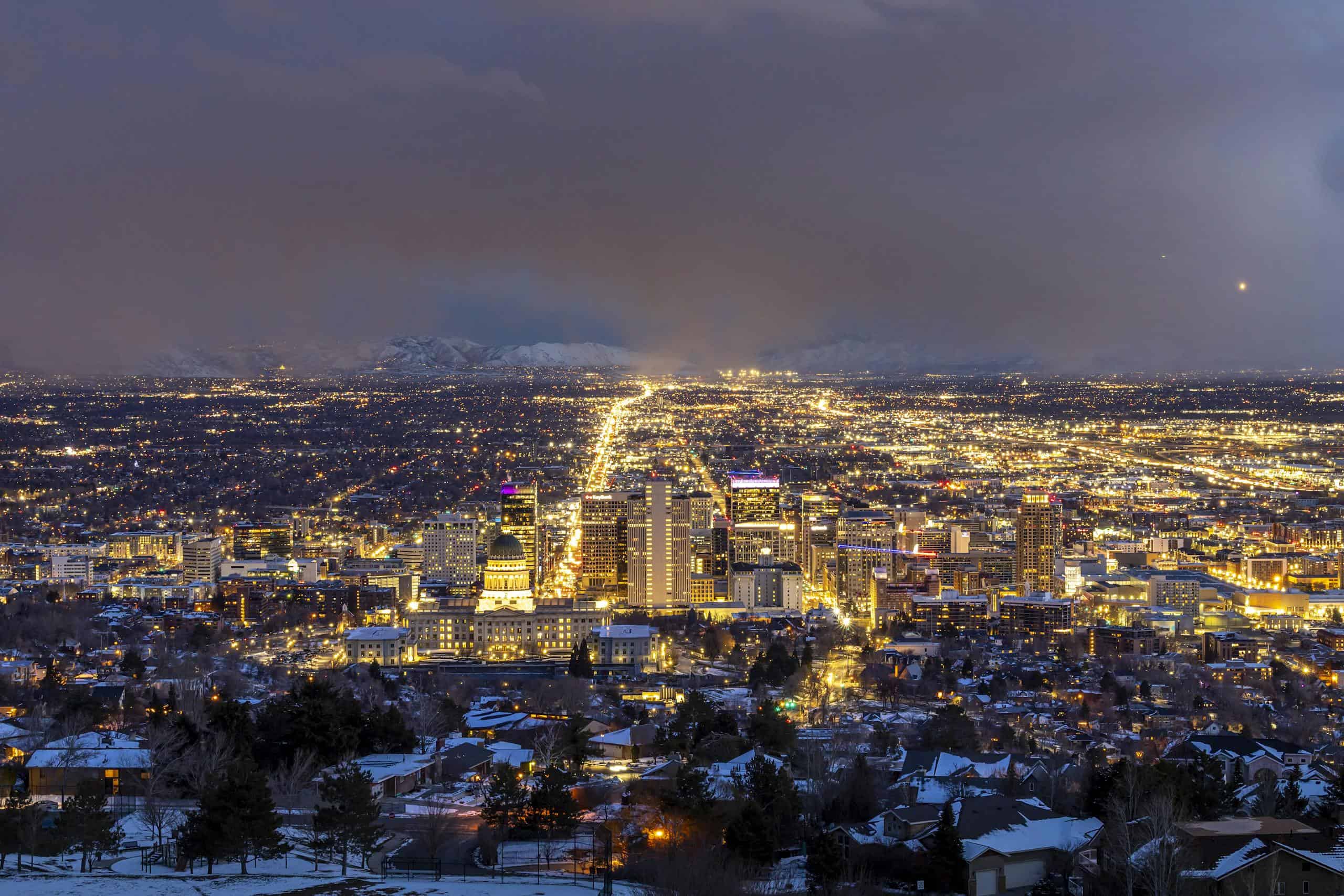 A breathtaking aerial view of Salt Lake City illuminated at night, showcasing its urban beauty.