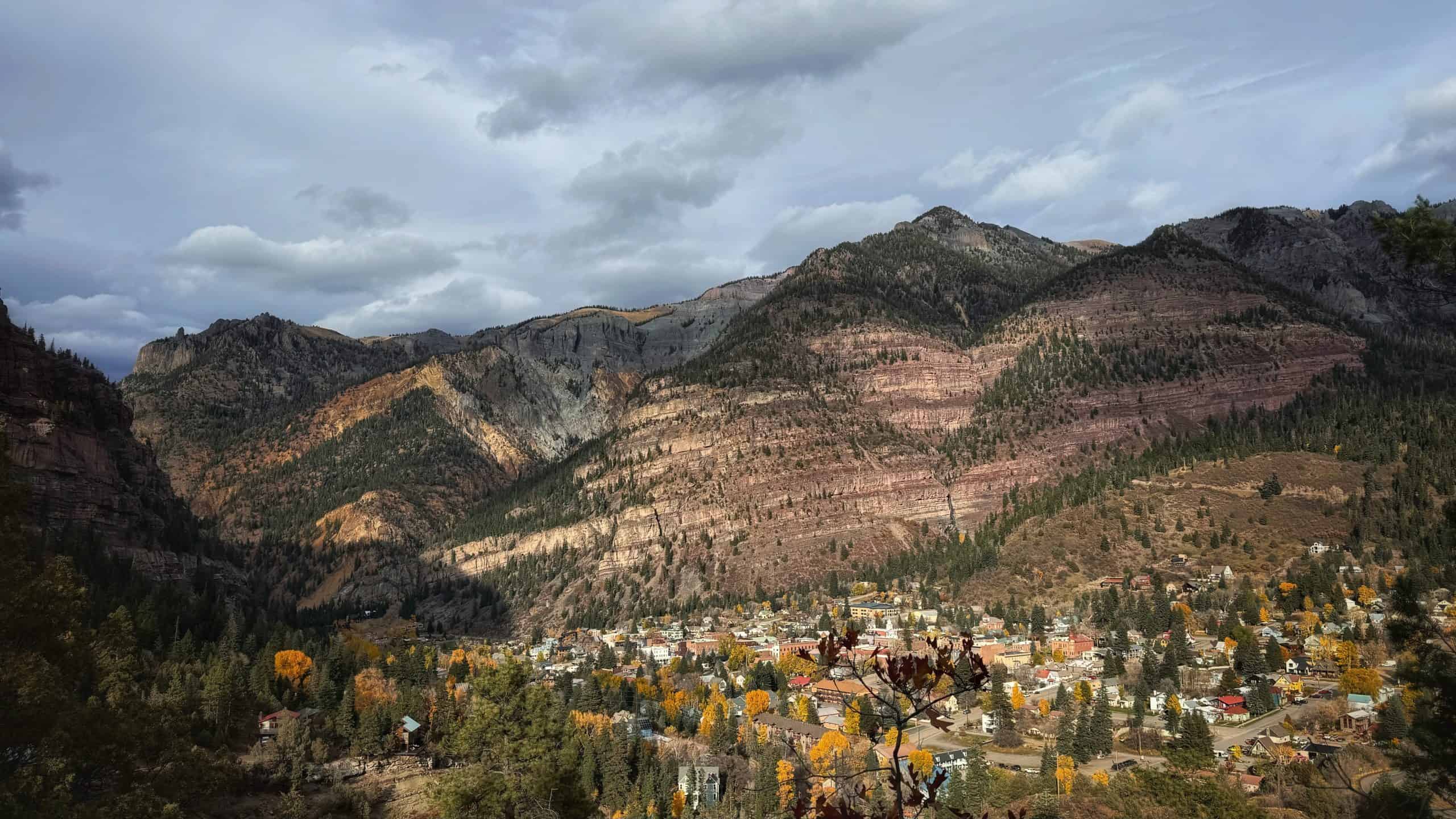 A wide Panoramic view of Ouray from the Perimeter Trail, nestled against the tall Box Canyon walls and under moody skies