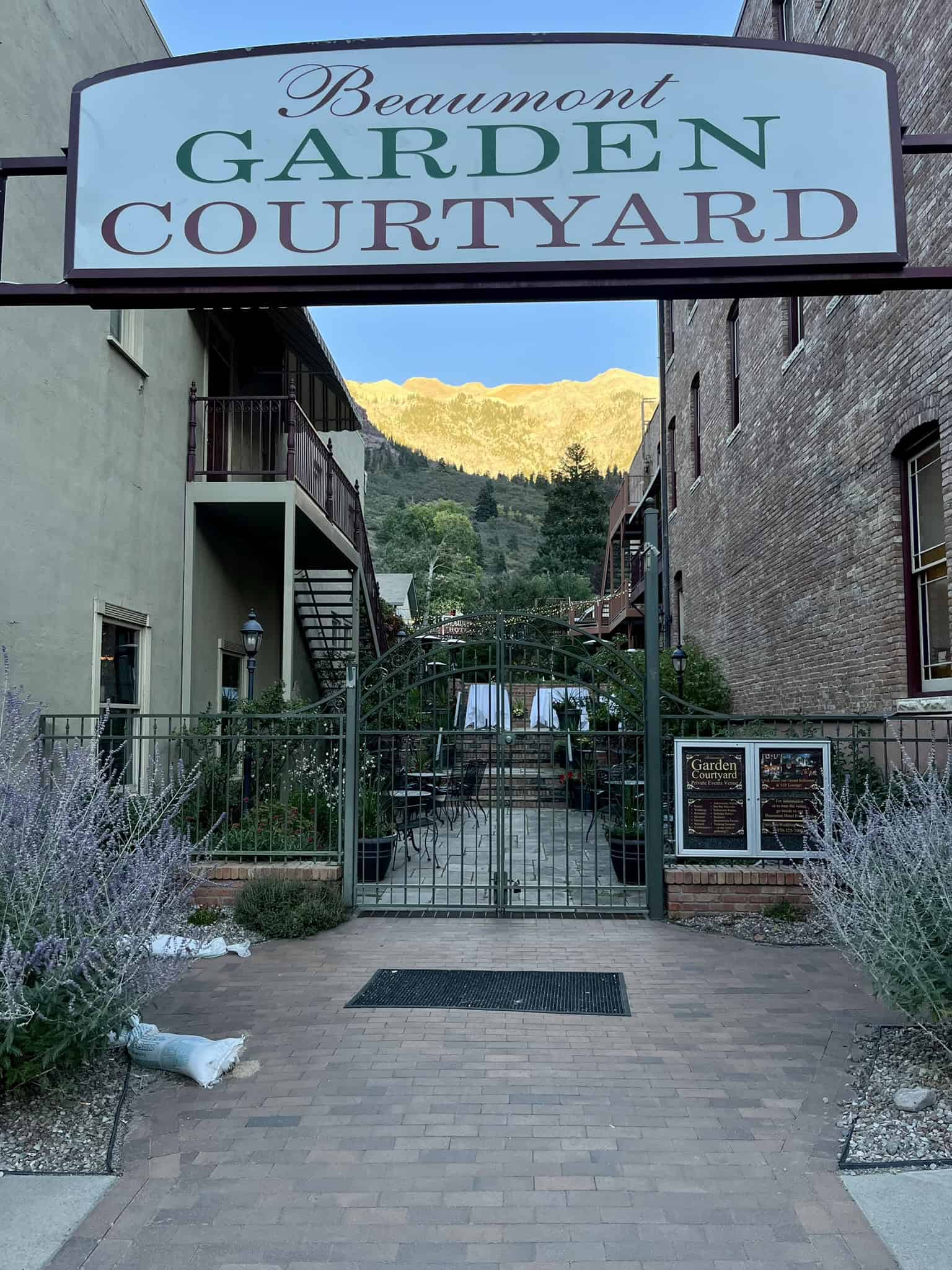The entrance to Beaumont Garden Courtyard with a view of the mountains, offering a charming stay among scenic surroundings