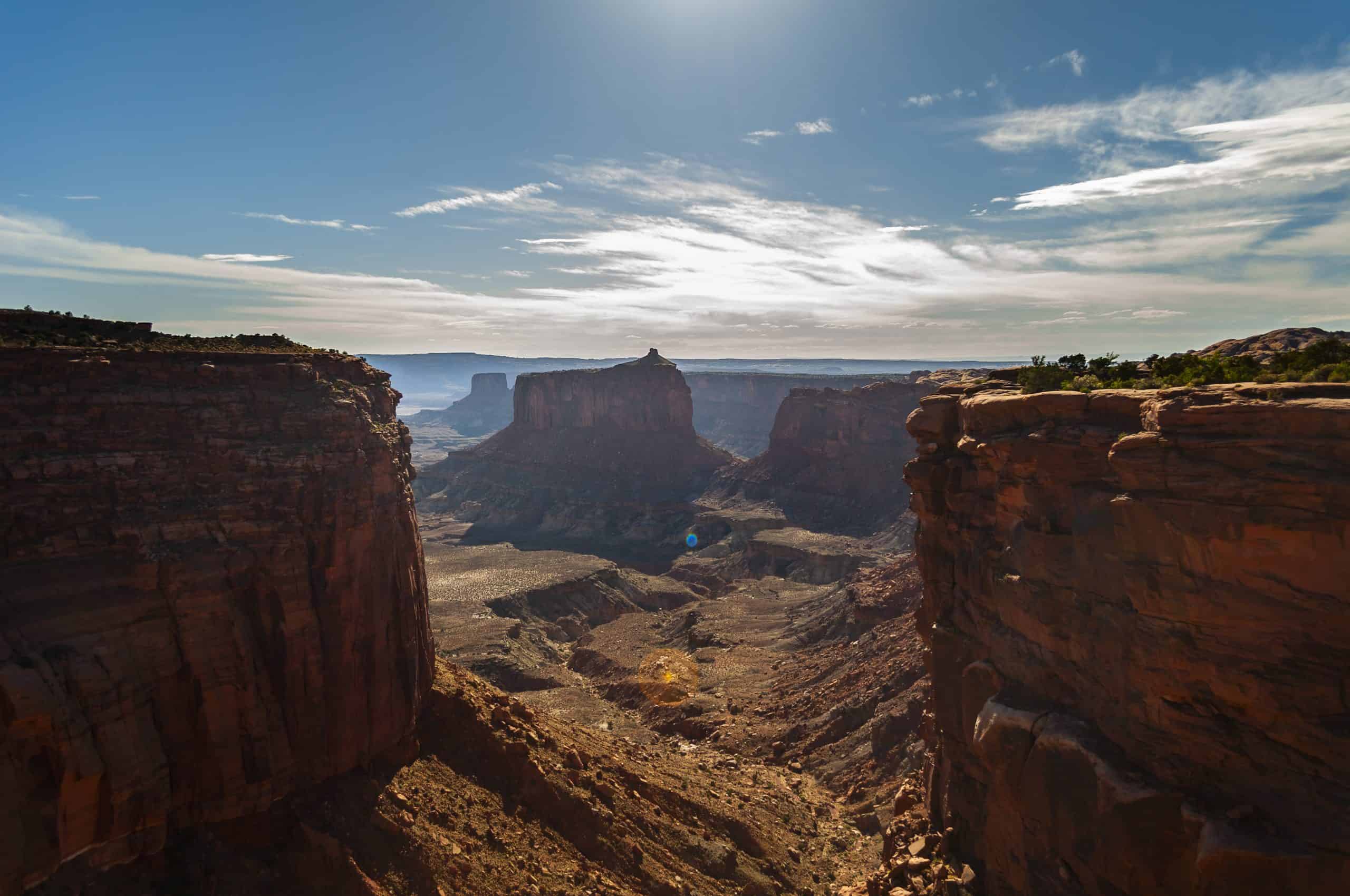 sweeping canyon vista framed by towering red rock cliffs in Canyonlands National Park.